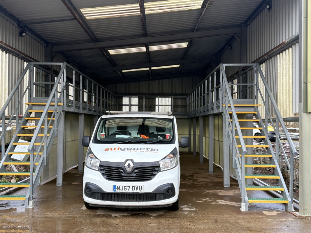 branded van parked between safety access platforms on both sides of a wash down station